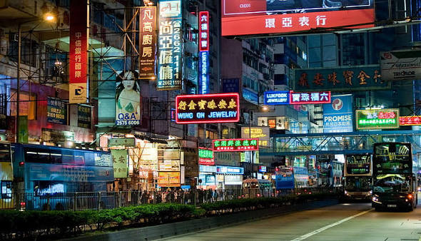 Hong Kong street glowing with neon signs